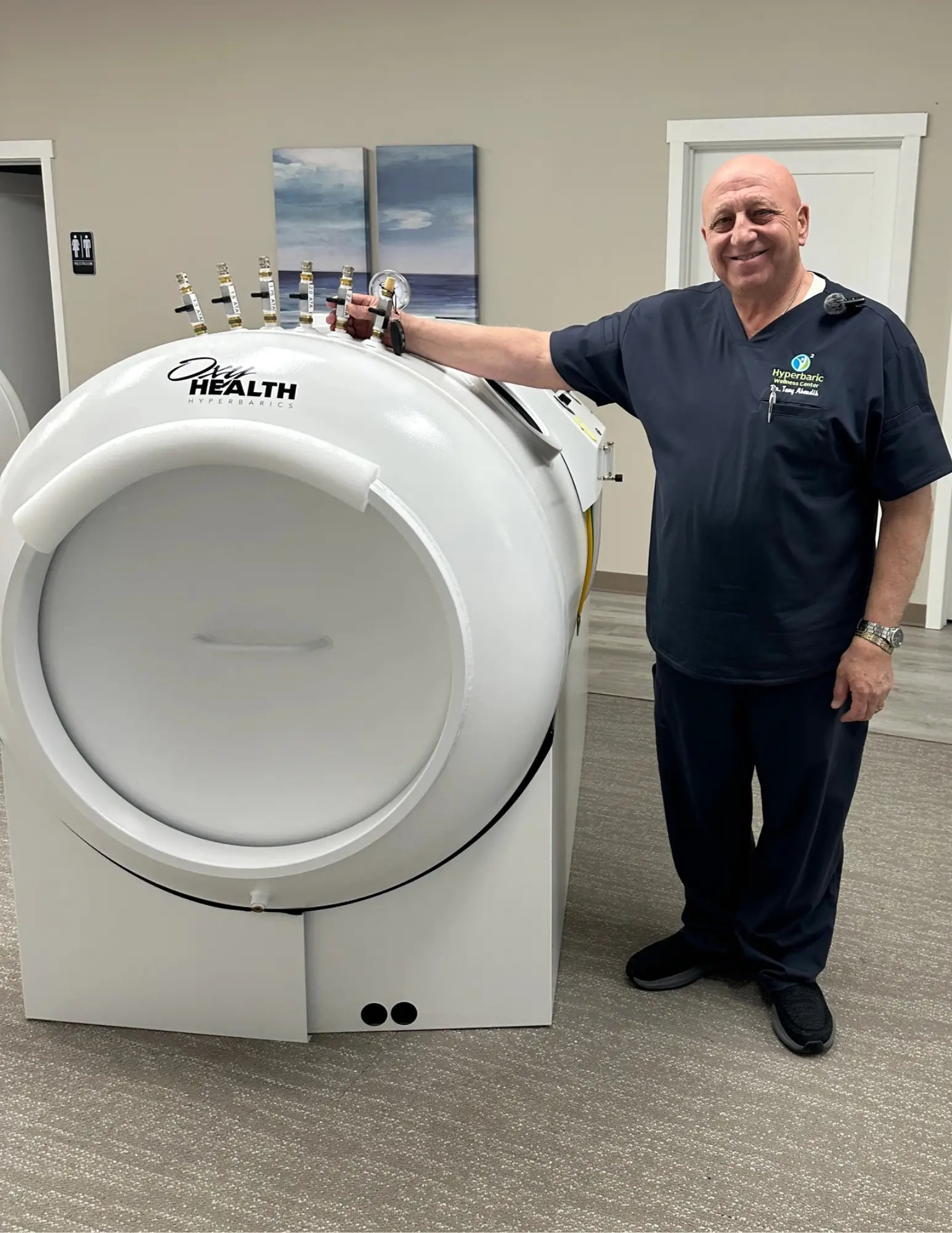 Dr. Tony with an HBOT machine at Michigan Health & Wellness